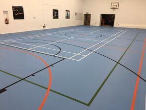 Sports hall multi purpose sports flooring installation with basketball and netball court markings