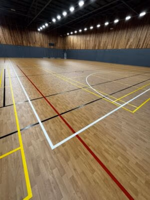 Indoor volleyball court flooring installation with sprung sports flooring and bespoke court markings