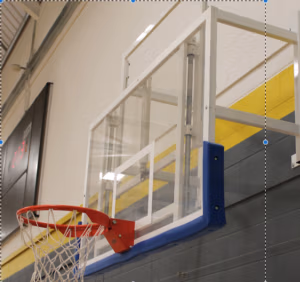 Wall mounted height adjustable basketball goals installed in sports hall